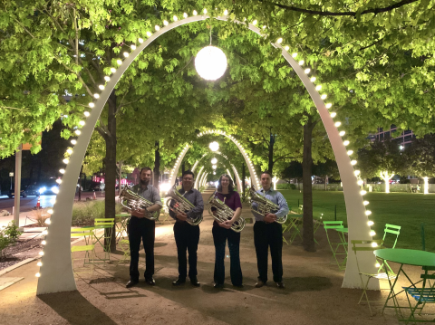 Portrait of 4 euphonium students under a lighted arch