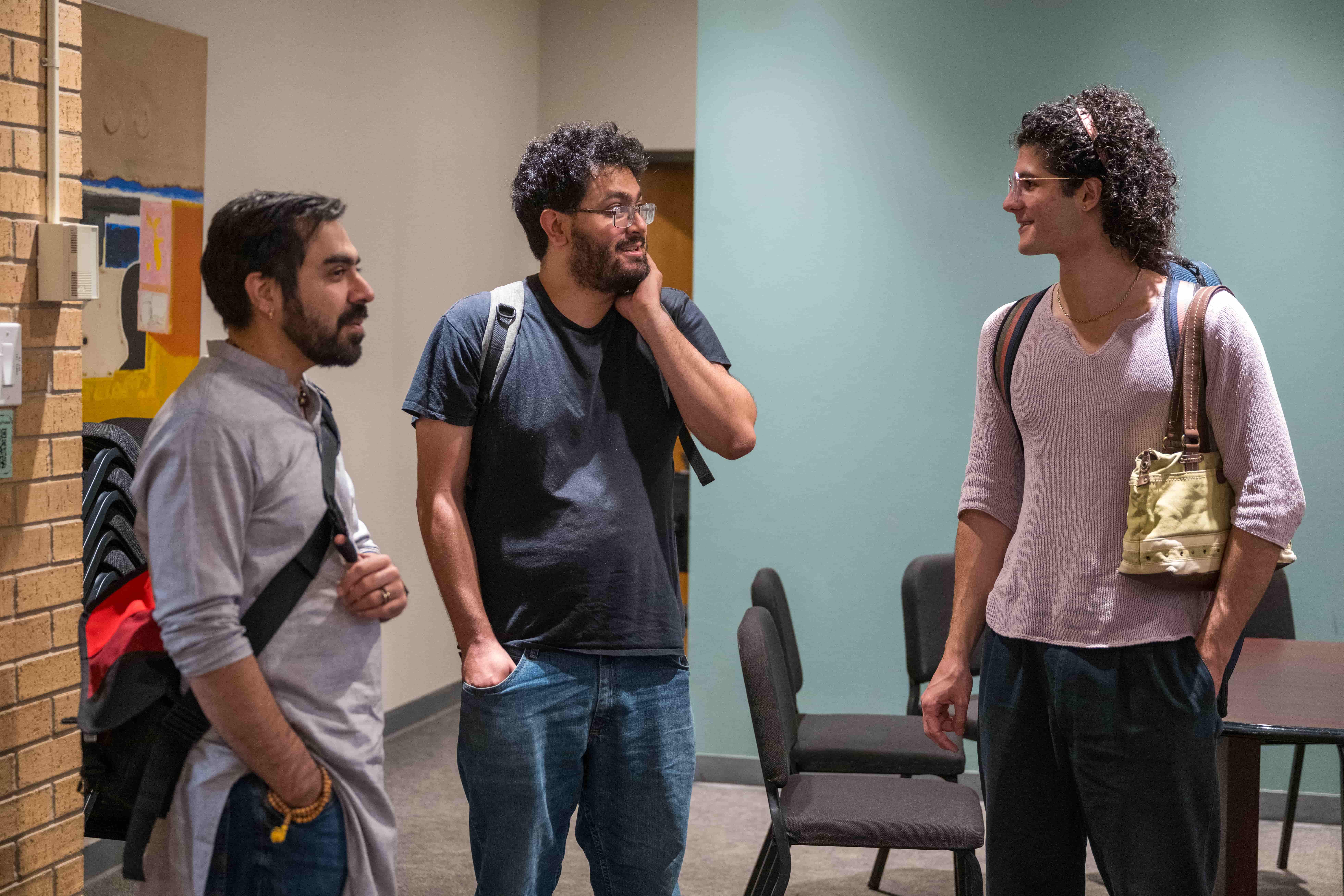 Group of three students talking to each other