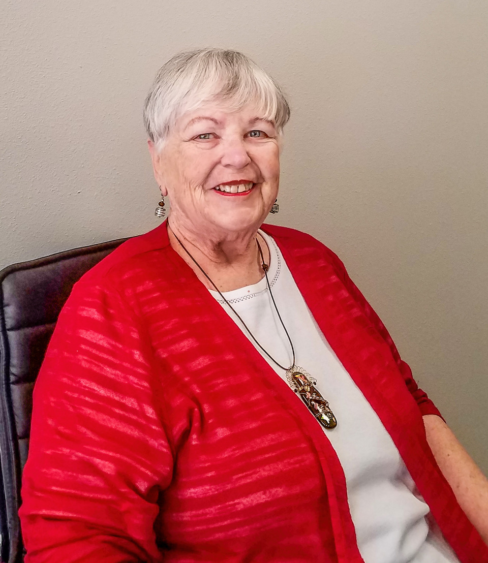 M. Jean Greenlaw sitting in chair