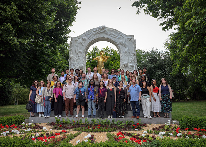 A Cappella Choir posing with a landmark