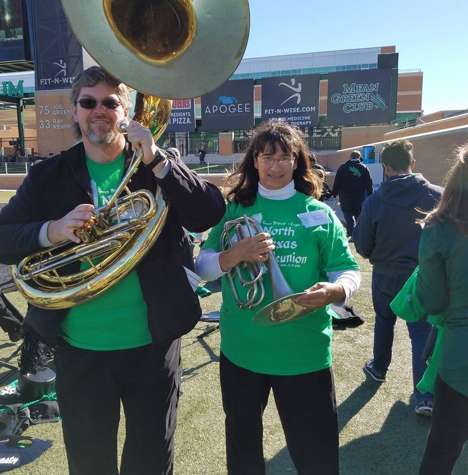 Green Brigade alumni playing brass instruments