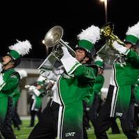 A baritone player leans back and blasts the halftime show