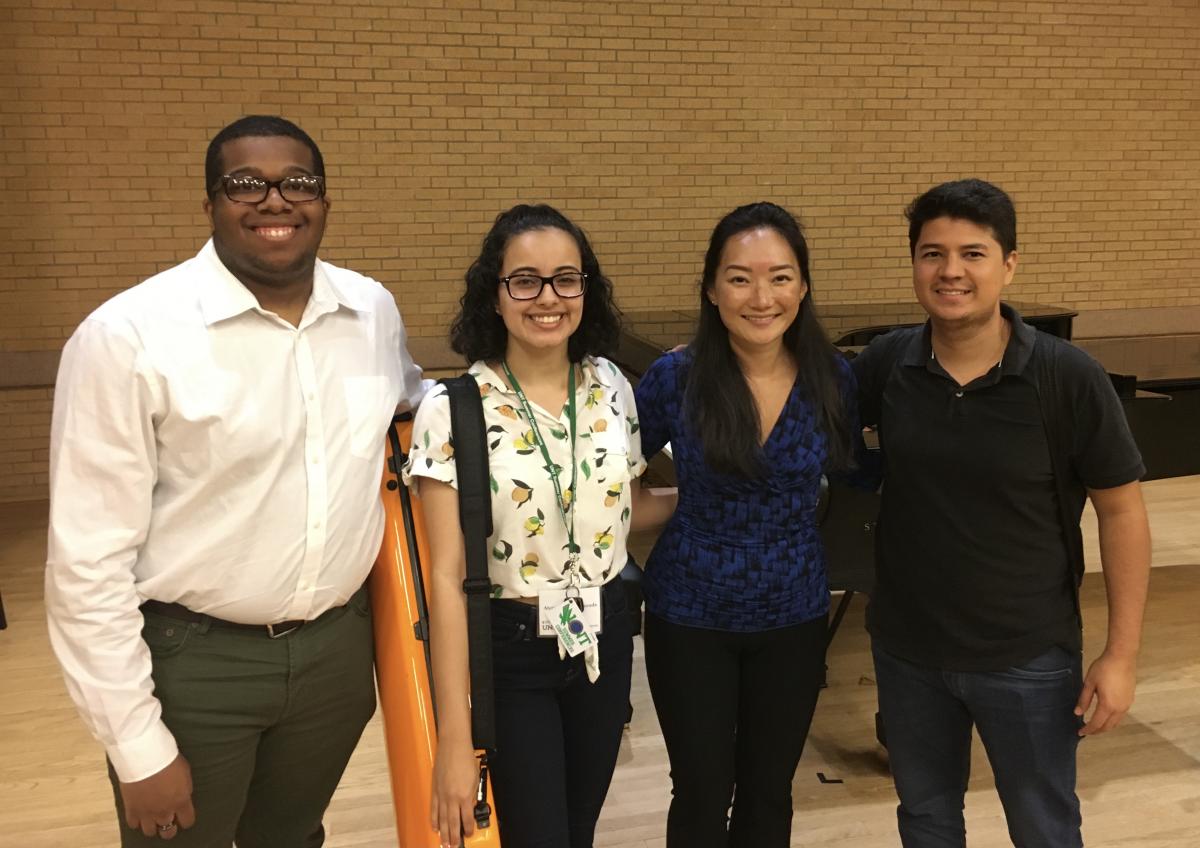 A group of four institute participants smiling for the camera