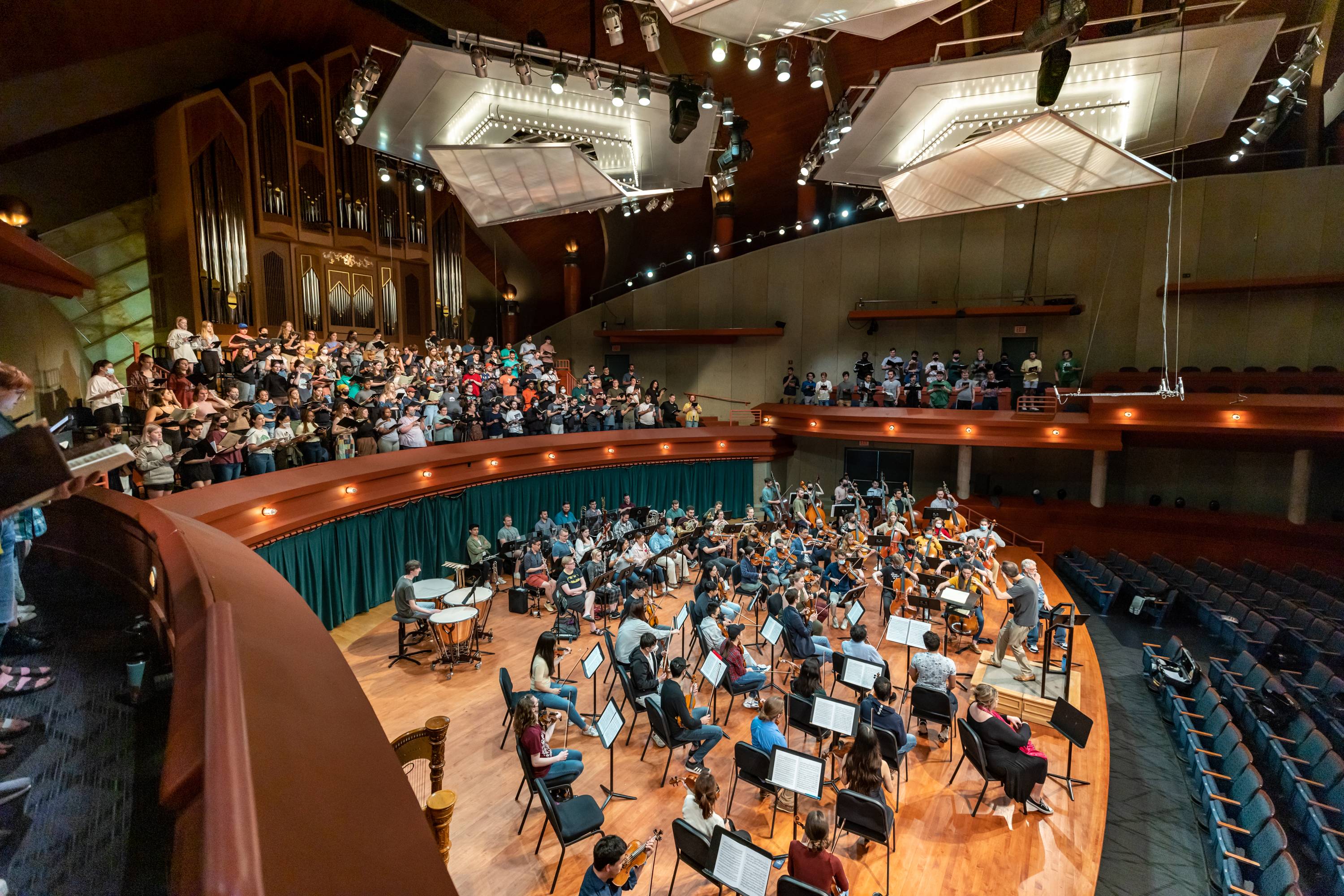 Rehearsal in Winspear Hall of UNT Grand Chorus, orchestra on main stage and choir in choir loft.