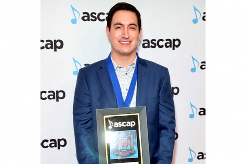 Daniel James Chan posing with ASCAP Award