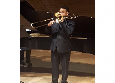 Eston Bell performing on stage with his trombone