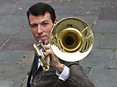 Nick Finzer, holding trombone