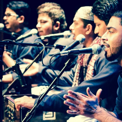 Qawwali singers performing in front of microphones